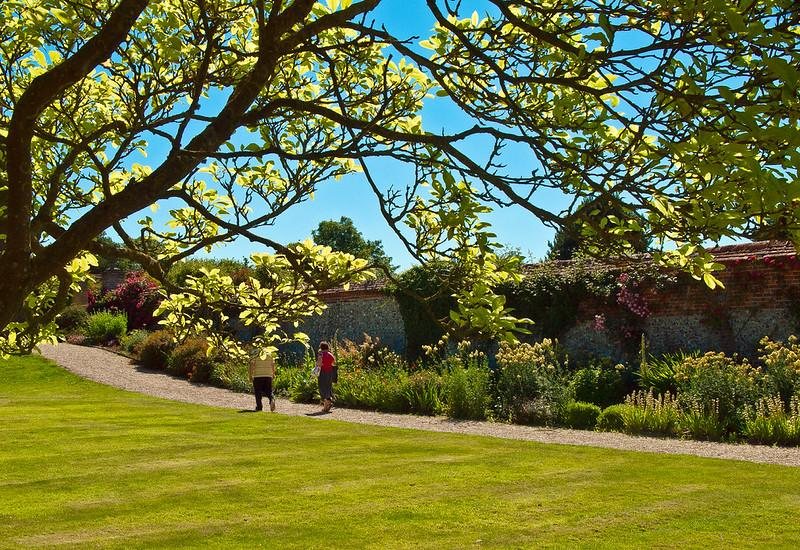 Visitors in a walled garden in full bloom